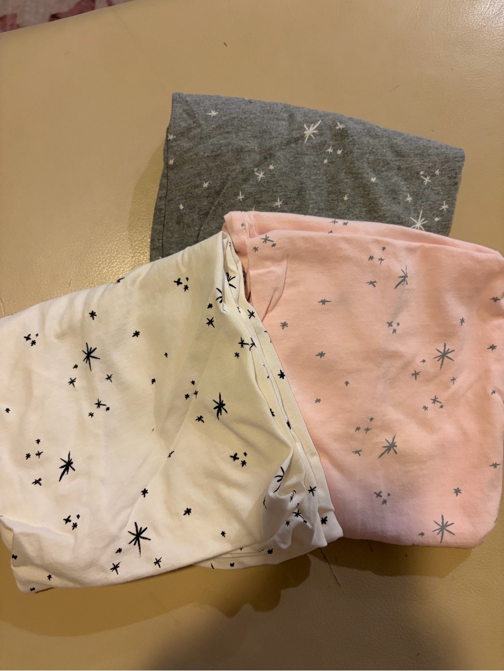 SNOO bassinet sheets in grey, pink, and white